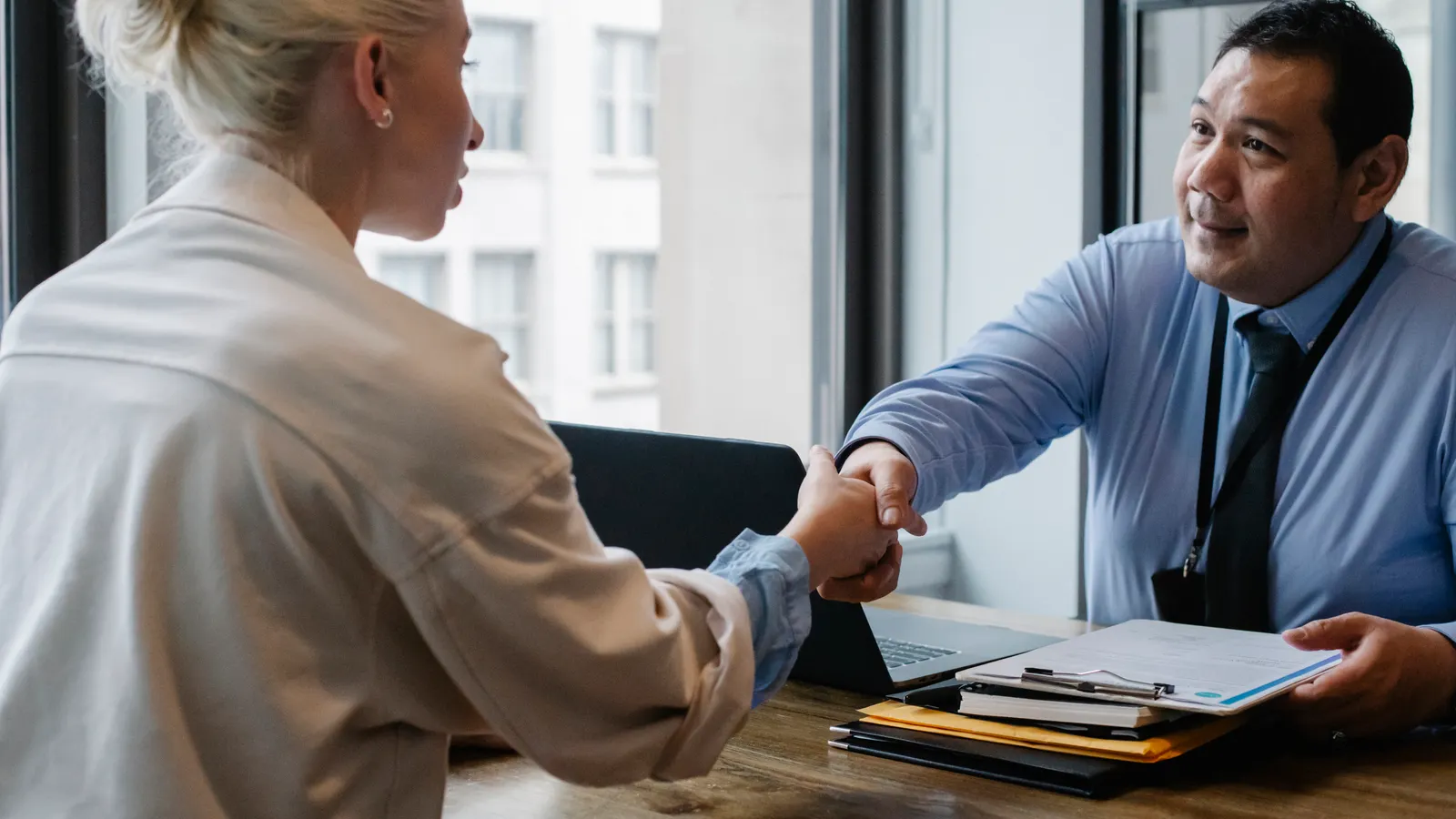 Car accident lawyer free consultation, an attorney meeting a client across a desk