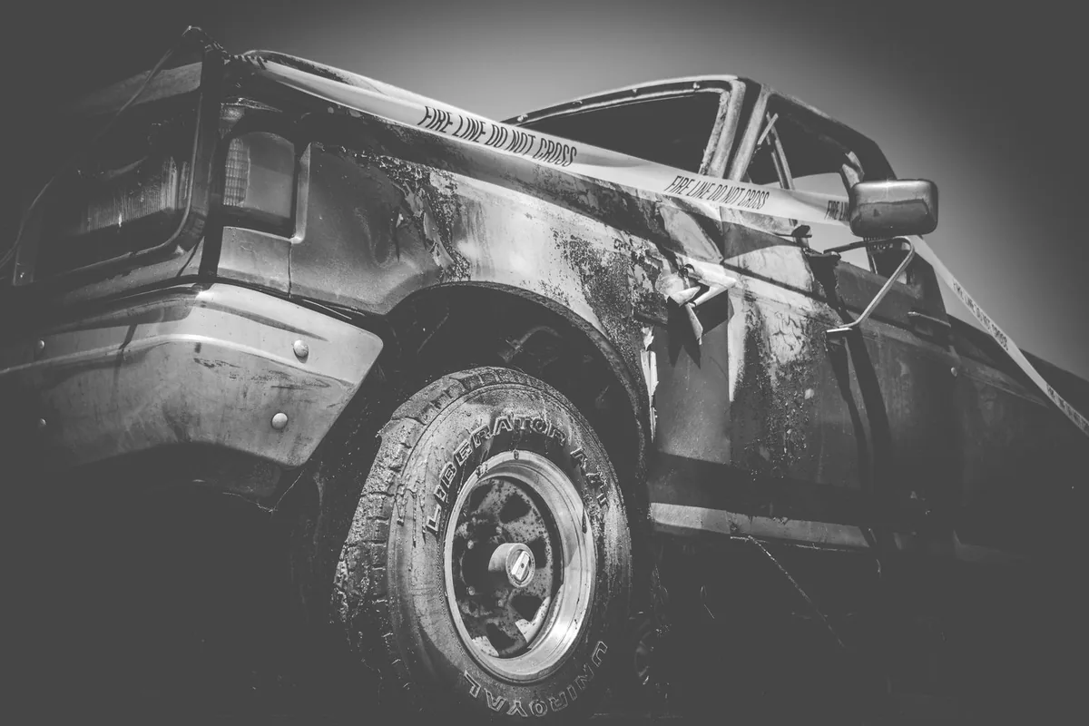 Richardson car accident lawyer: a wrecked vehicle behind fire line tape after a serious crash