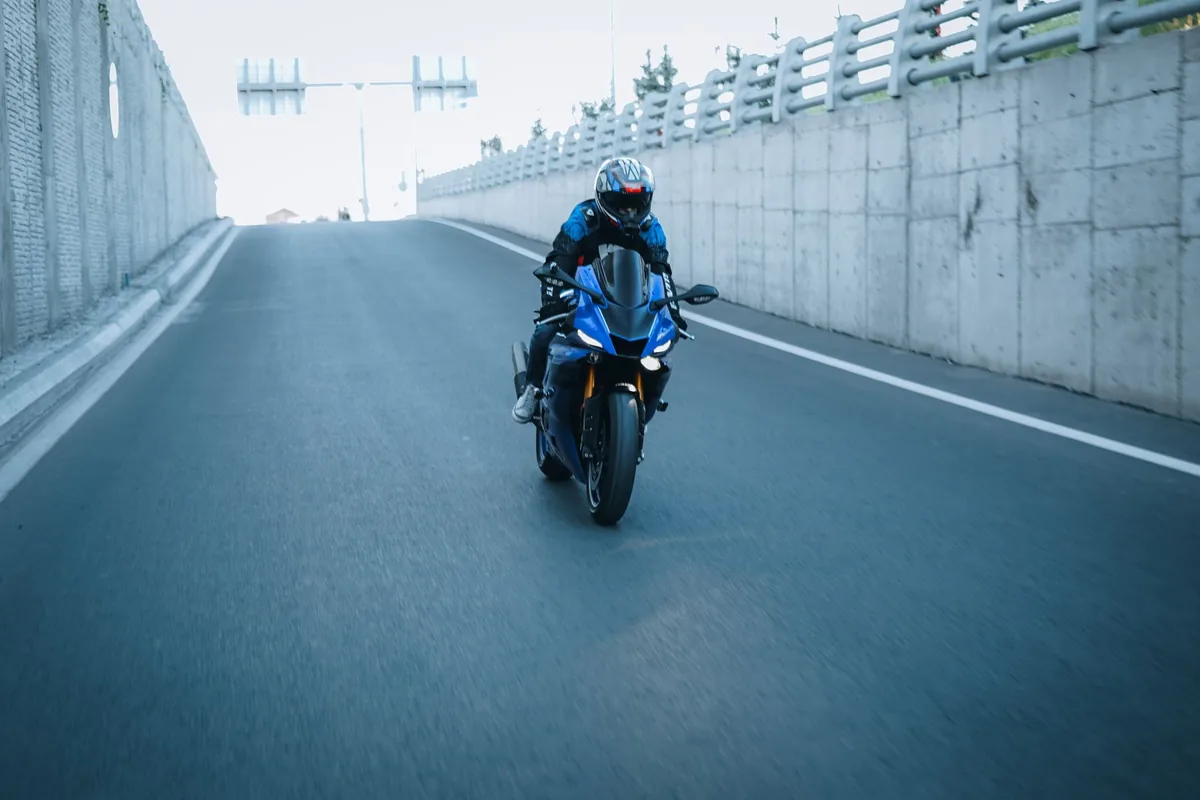 Richardson motorcycle accident lawyer: a rider alone on a road between concrete barriers
