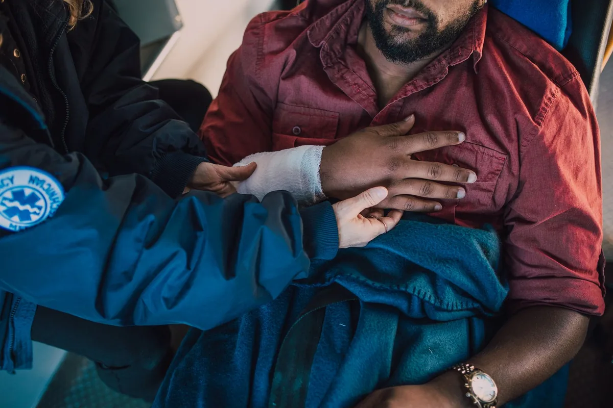 Mansfield personal injury lawyer: a paramedic treating an injured man at the back of an ambulance