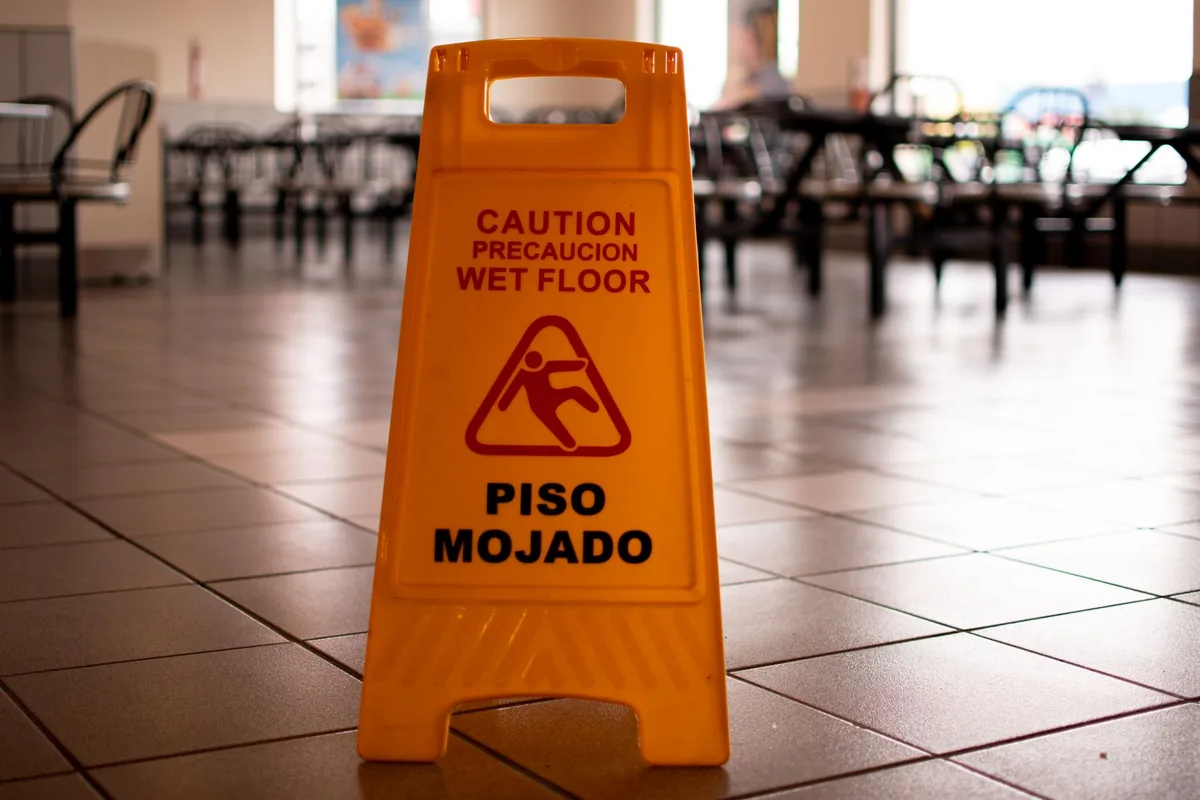 Abogado de responsabilidad del propietario en Fort Worth: un letrero de piso mojado sobre el suelo de un negocio