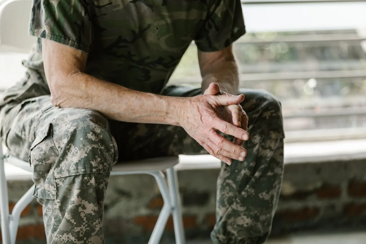 Richardson VA disability lawyer: a veteran in uniform sitting with hands clasped