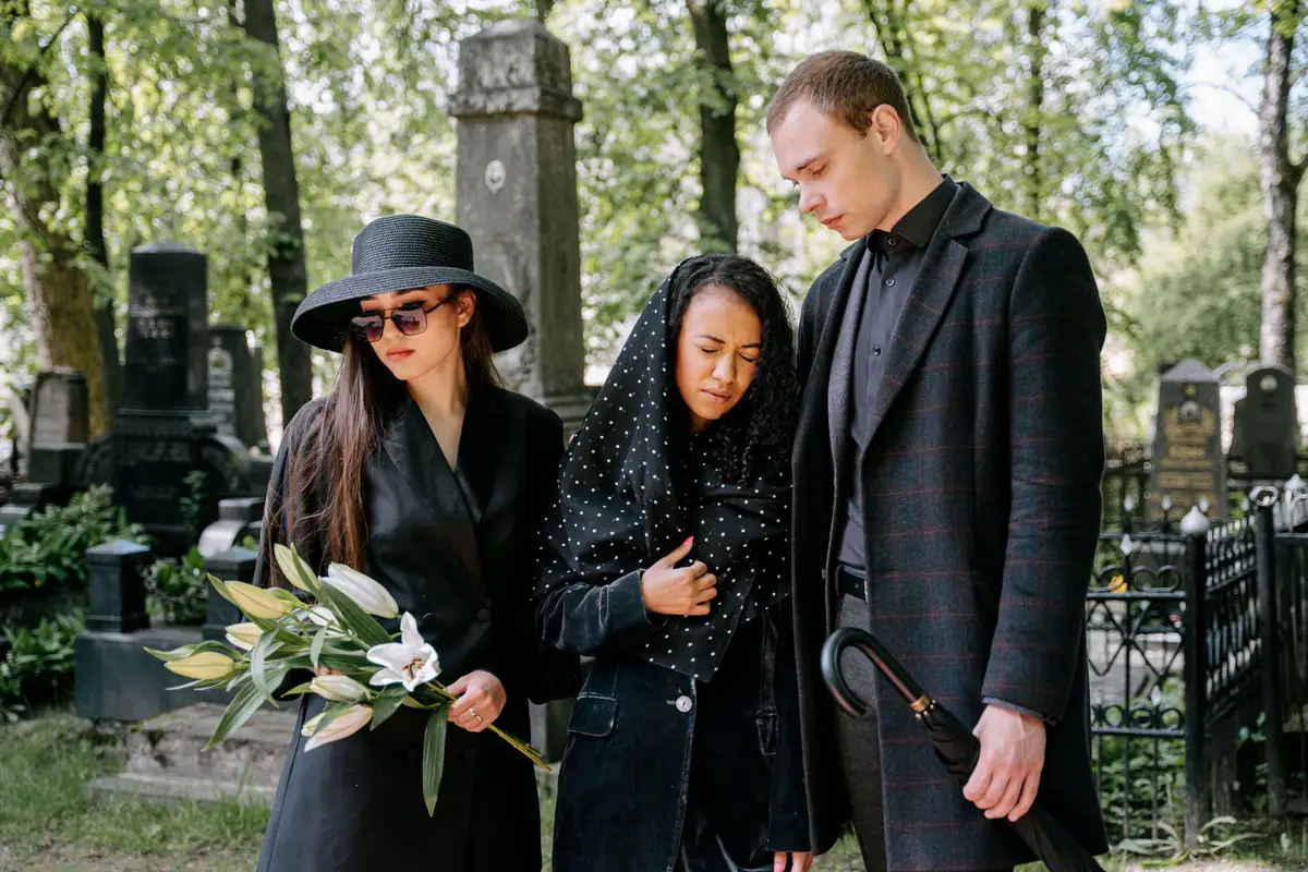 Richardson wrongful death lawyer: mourners walking together through a cemetery with flowers